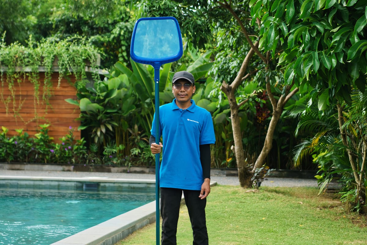 Skimming and cleaning a resort pool in Bali