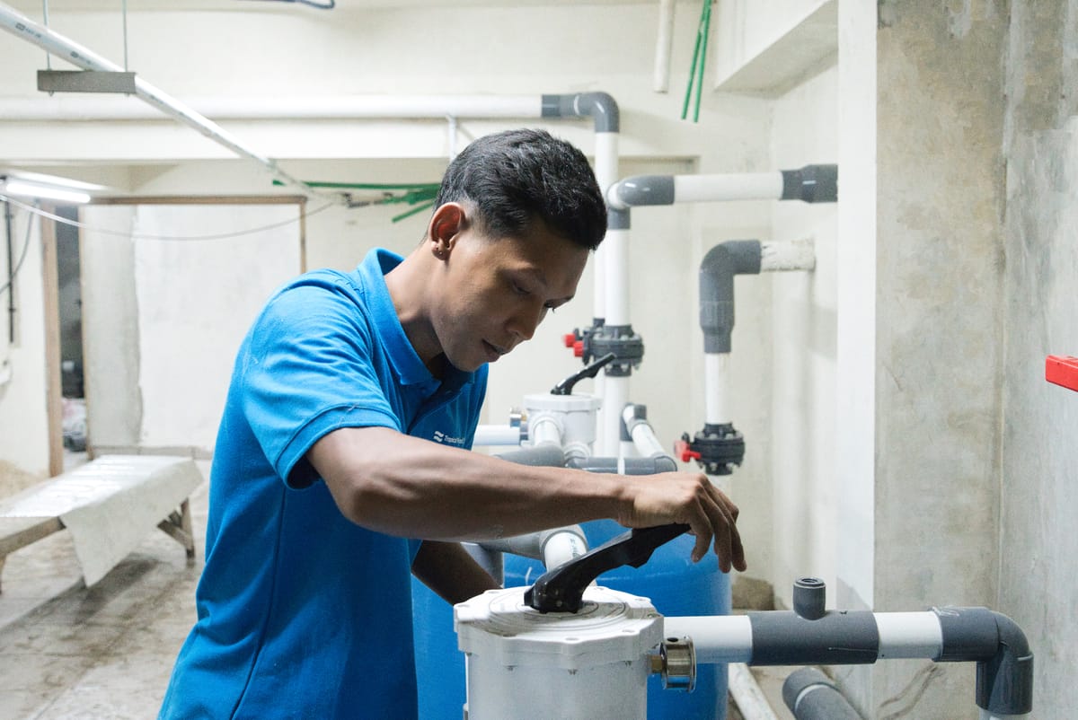 A Tropical Pool technician plumbing the pump room and filtration during a pool build in Bali