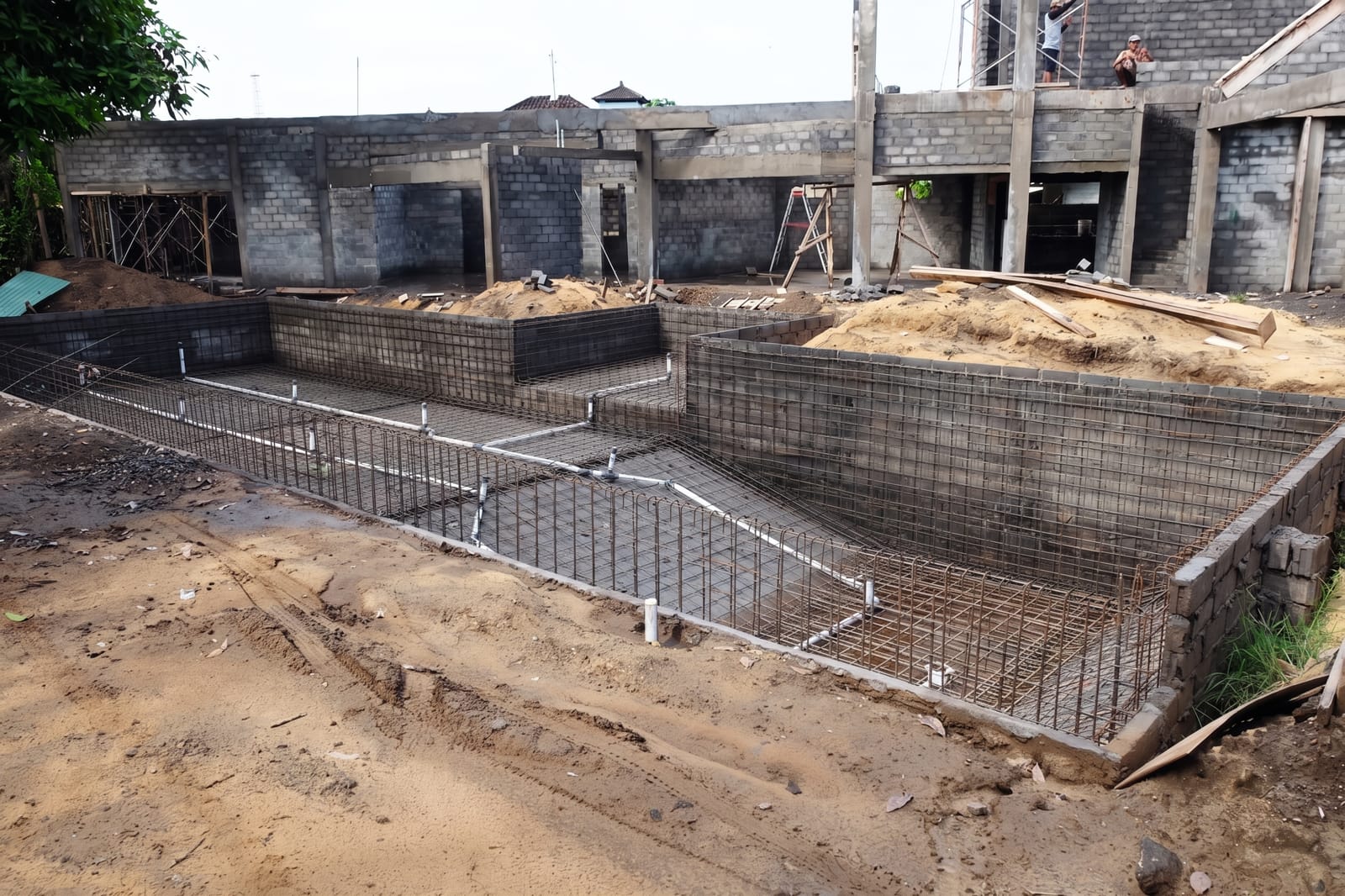 Steel reinforcement mesh set out for a large pool before the concrete pour on a Bali build