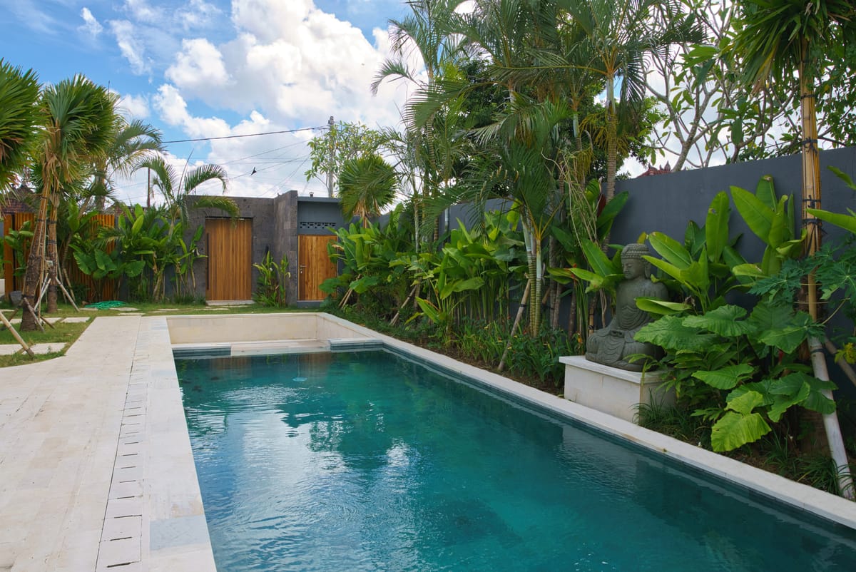 Wide view of a minimalist pool with crisp stone coping