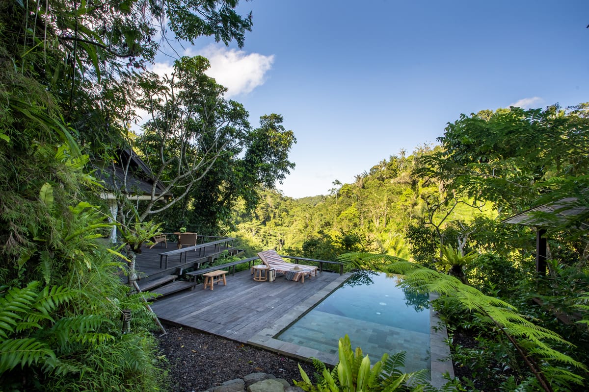 Plunge pool on a timber deck overlooking the jungle valley at a luxury resort villa in Bali