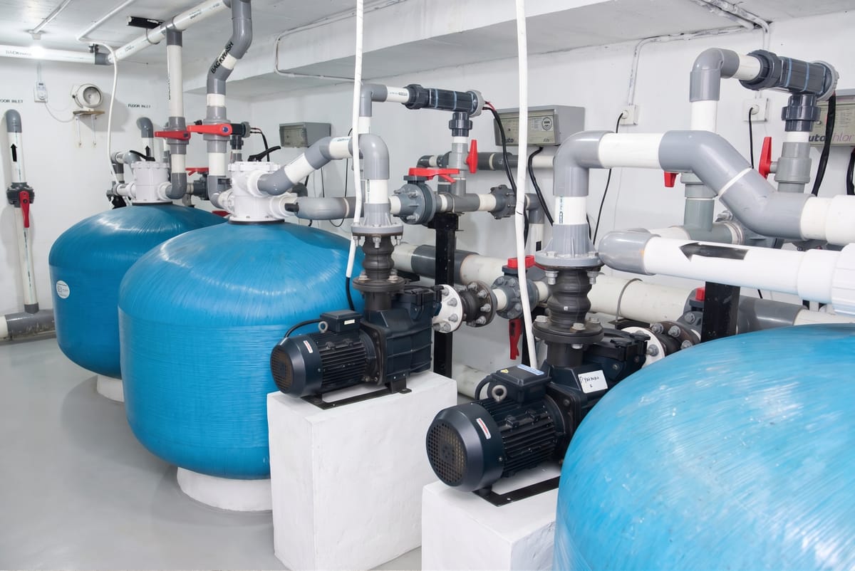 Pump and filter bank in a commercial pool pump room in Bali