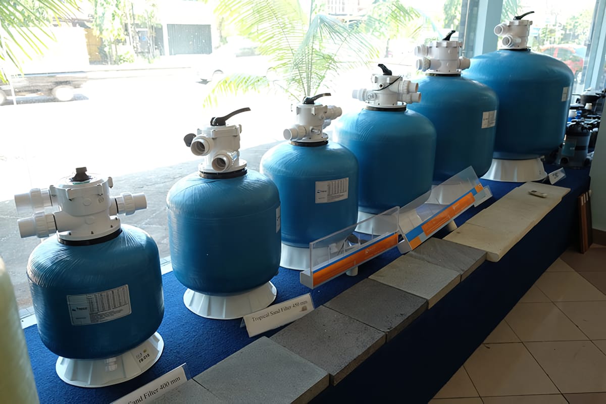 Sand filter and manifold in a pool pump room in Bali