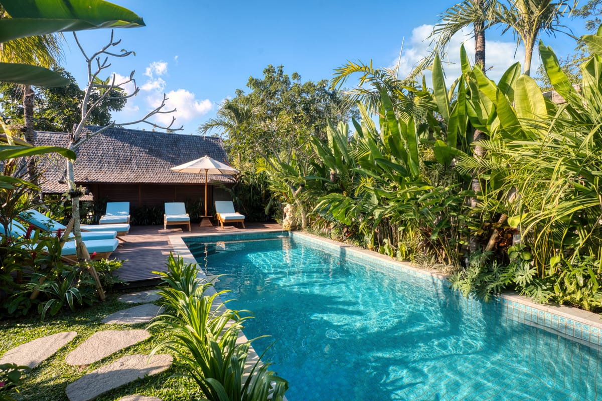 Private villa lap pool bordered by dense greenery in Uluwatu, Bali